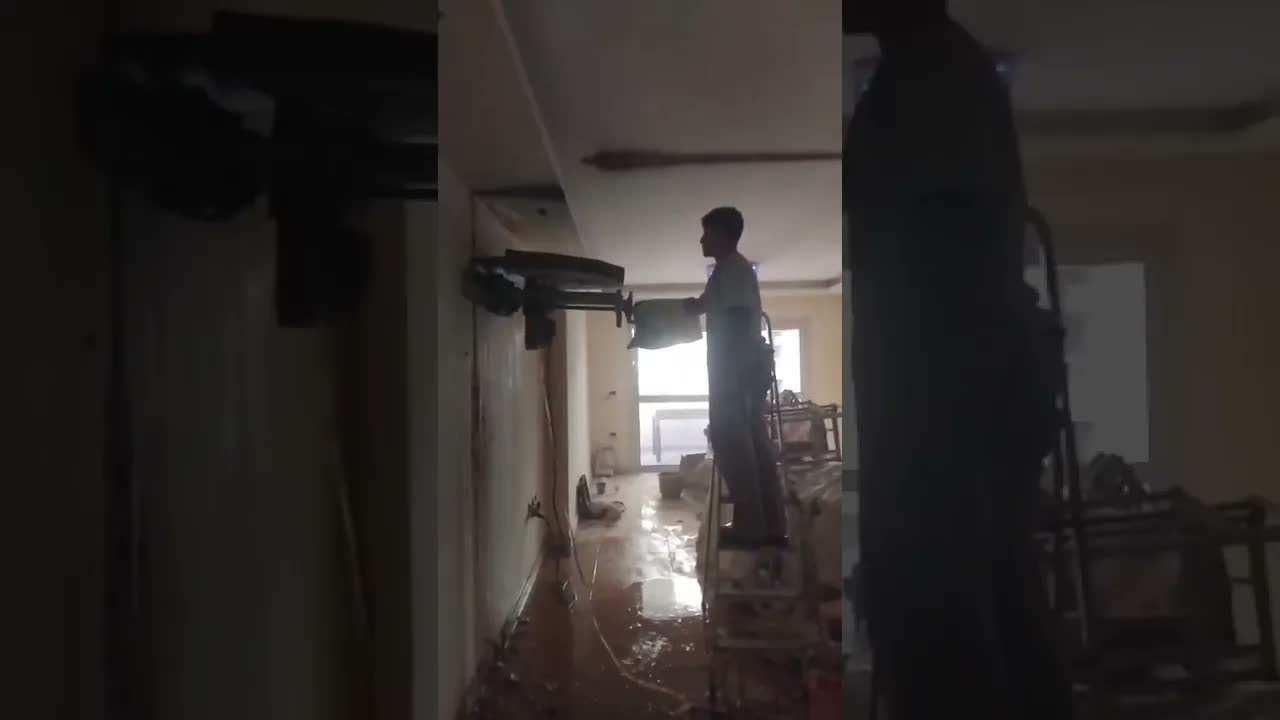 لقطة من فيديو قص أفقي مرتفع في حائط خرساني داخل شقة قائمة